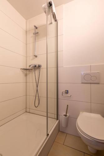a bathroom with a shower and a toilet at Nani City Hotel in Zürich