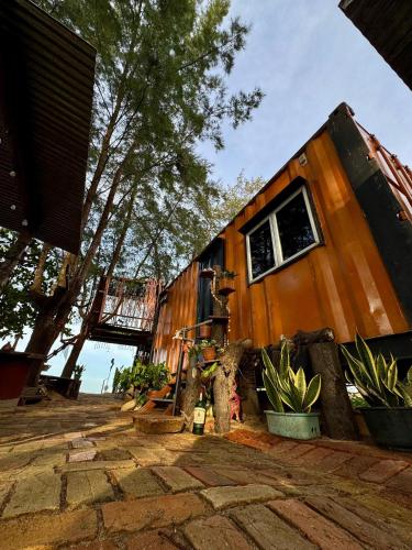a tiny house sitting on top of a patio at Pok Mat Beach Cabin in Marang