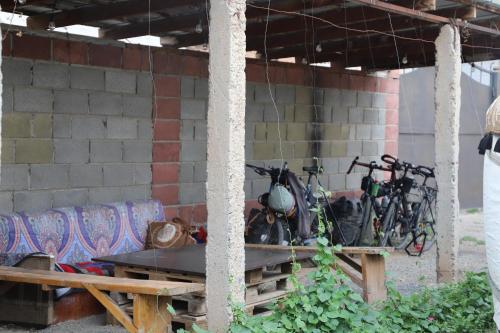a group of bikes parked next to a brick wall at Naryn Guest House in Naryn