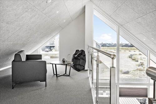 Una sala de estar con una silla y una mesa. en 918-Hvide-Sande-Langsand-182, en Hvide Sande