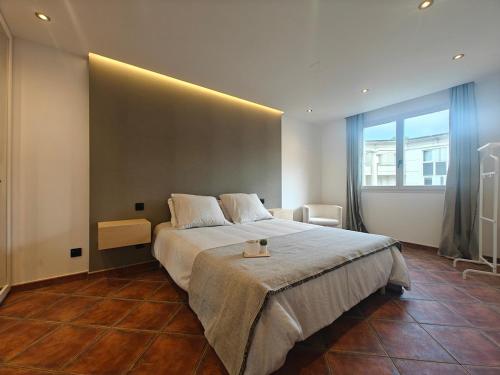 a bedroom with a large bed and a large window at Premium Apartment in Antigone Luxury and comfort in Montpellier