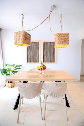 a dining room table with two chairs and fruit on it at Rincon de Paz in Corralejo