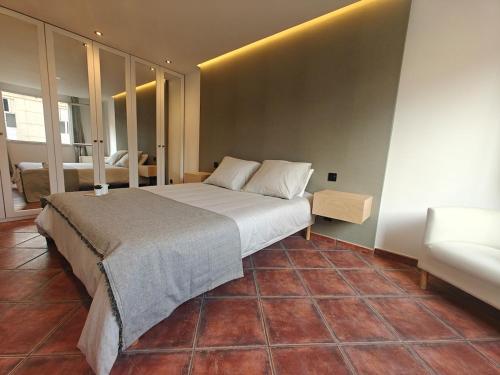 a bedroom with a large bed and a couch at Premium Apartment in Antigone Luxury and comfort in Montpellier