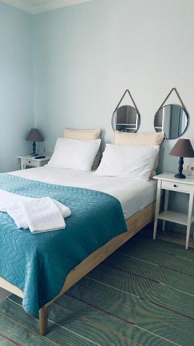 a bedroom with a large bed and two night stands at Theros Room in Nydri