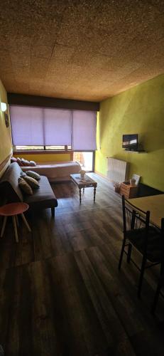 a living room with a couch and a table at Mimos House's Rio e Serra in São Pedro do Sul