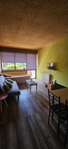 a living room with a couch and a table at Mimos House's Rio e Serra in São Pedro do Sul