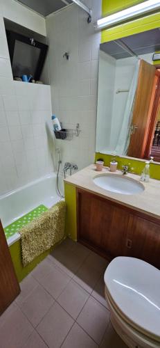 a bathroom with a sink and a tub and a toilet at Mimos House's Rio e Serra in São Pedro do Sul