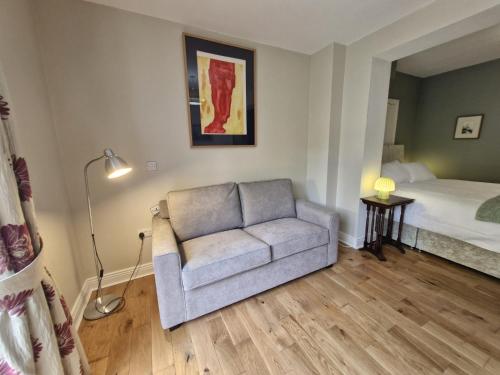 a living room with a couch and a bed at The Garden Room in Kilkenny