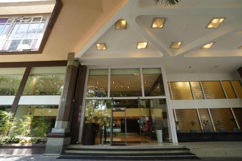 an office building with a lobby with glass doors at Royal Orchid Central Bangalore, MG Road in Bengaluru