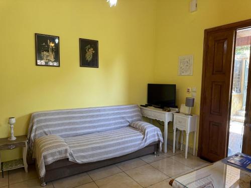 a bedroom with a bed and a desk with a television at Ilias in Paramonas
