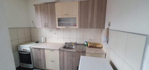 a small kitchen with a sink and a stove at Kicevo - A great apartment for you in Karpoš