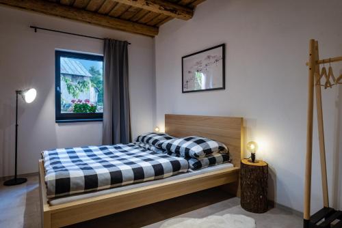a bedroom with a bed with a checkered blanket at Apartmán v Chate Besnik - Telgárt Resort in Telgárt