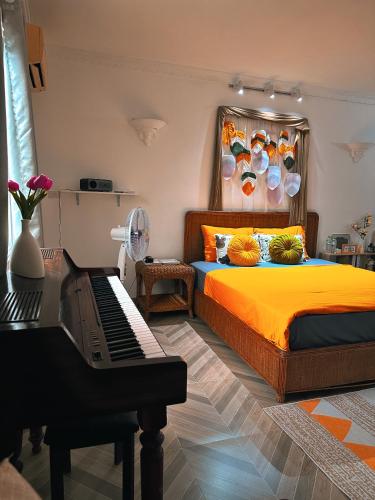 a bedroom with a bed and a piano at Horizon Home - Netflix n Chill in Ho Chi Minh City