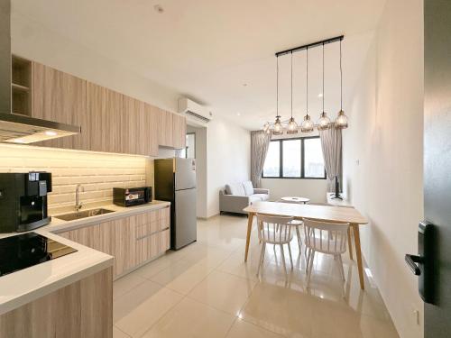a kitchen with a table and chairs in a room at Iconic Regency by Li in Gelugor