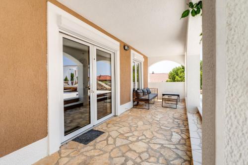 a hallway of a home with large windows and a patio at Dvor Aaki in Novi Vinodolski
