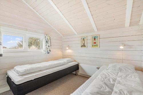 a bedroom with two beds and a window at 555-Hvide-Sande-Tornbjerrevej-32 in Havrvig