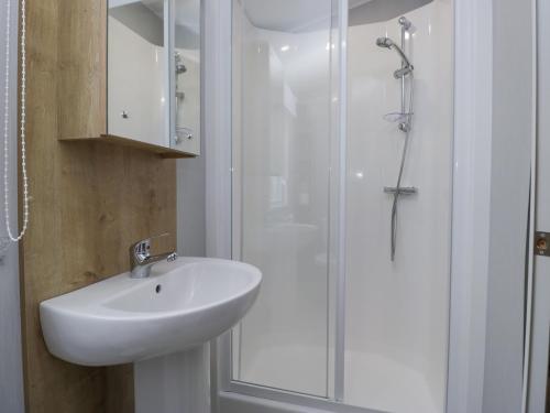 a bathroom with a sink and a shower at Sandpiper in St Bees