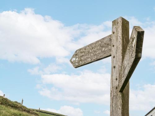 a wooden cross on top of a hill at Sandpiper in St Bees