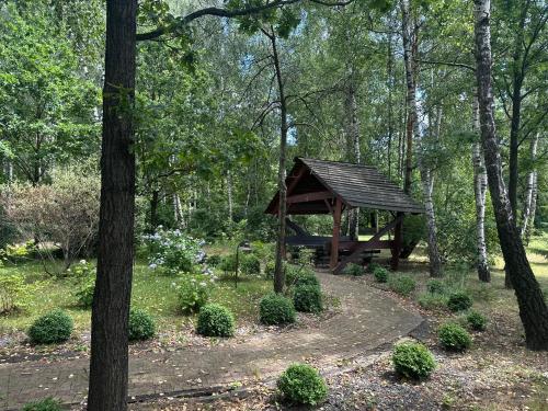a picnic shelter in the middle of a forest at Hotel Dudek in Mniów