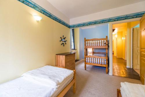 a bedroom with two beds and a crib in it at Moulin de la Touche - Manoir Piscine Nature in Plouguenast Langast