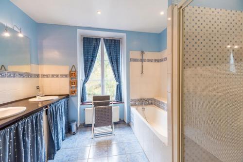 a bathroom with a tub and a sink and a shower at Moulin de la Touche - Manoir Piscine Nature in Plouguenast Langast