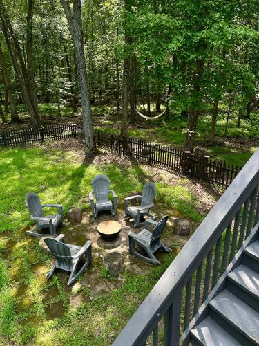 a group of chairs and a table and a table and chairs at Poconos Modern Chalet-Hot Tub-Home Theater-Lake in East Stroudsburg