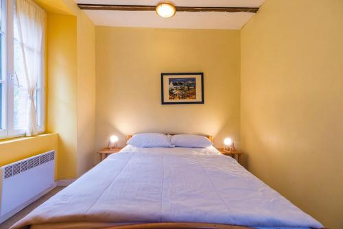 a bedroom with a large bed with two night stands at Moulin de la Touche - Domaine Piscine in Plouguenast Langast