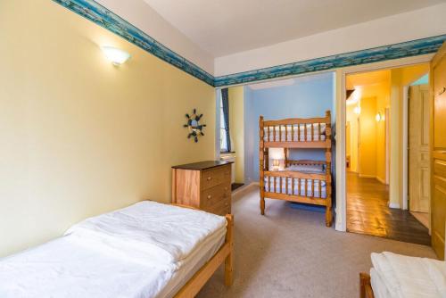 a bedroom with two beds and a crib in it at Moulin de la Touche - Domaine Piscine in Plouguenast Langast