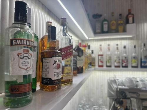 a group of bottles of alcohol on a shelf in a store at Hotel Dudek in Mniów