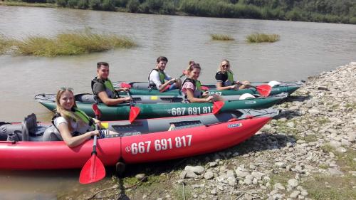 a group of people in kayaks on a river at Willa Wydra in Krościenko