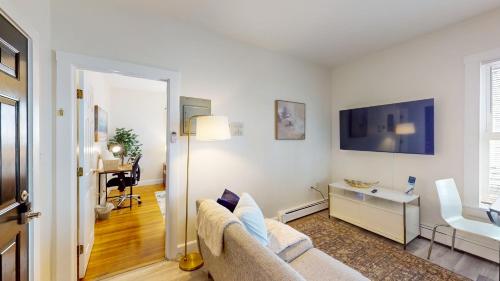a living room with a couch and a desk at MitHarvard, Central Sq, 2 room studio w Porch in Cambridge