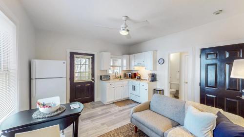 a living room with a couch and a table and a kitchen at Mitharvard, Central Sq, 2 Room Studio W Porch in Cambridge