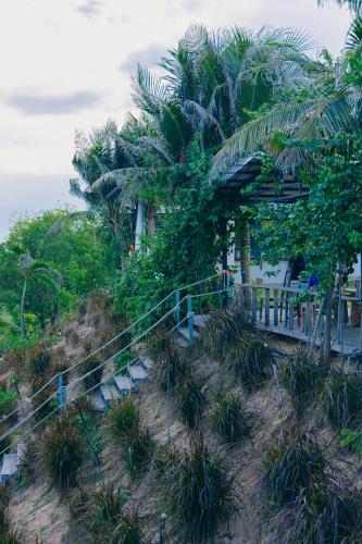 a house on a hill with palm trees at Peaceful Hill Homestay in Ke Ga