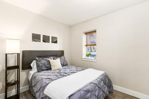 a bedroom with a bed and a window at Aisling Suites Furnished Apartments in Great Falls