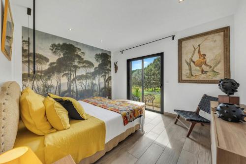 une chambre avec un lit et une grande fenêtre dans l'établissement Villa Salamba le charme avec piscine, à Draguignan