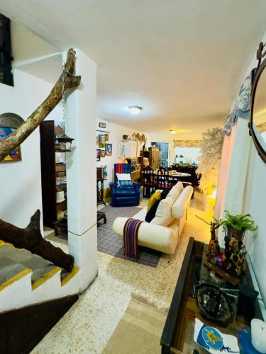 a living room with a white couch and a table at Centric & Private Full Apartment in Antigua Guatemala