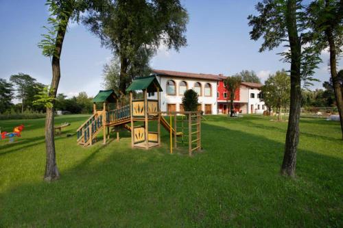 a park with a playground in the grass at Le Favole Agriturismo in Sacile