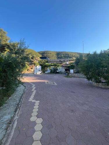 an empty parking lot with trees and a building at PetrosStudios in Néa Epídhavros