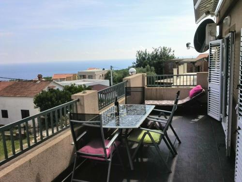 a patio with a table and chairs on a balcony at Apartments Mila Krimovica in Krimovice