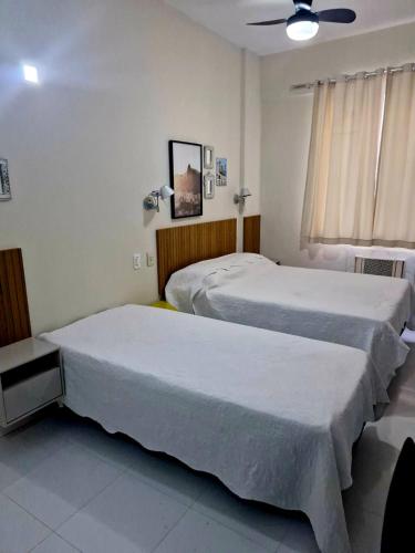 a bedroom with two beds and a window at Apt Copacabana perto da praia 710 in Rio de Janeiro