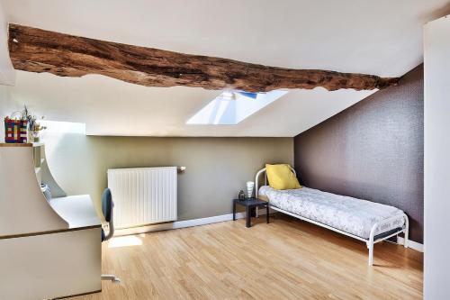 a room with a bed and a skylight at Le gite du pilot in Soucieu-en-Jarrest
