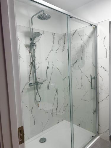 a shower with a glass door in a bathroom at Killarney Lakeview Studio Suite in Killarney