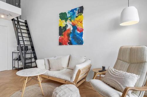 a living room with a couch and a chair at 781-Hvide-Sande-Norregade-2-nr-9 in Hvide Sande
