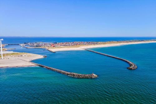 a long pier in the water next to a beach at 781-Hvide-Sande-Norregade-2-nr-9 in Hvide Sande