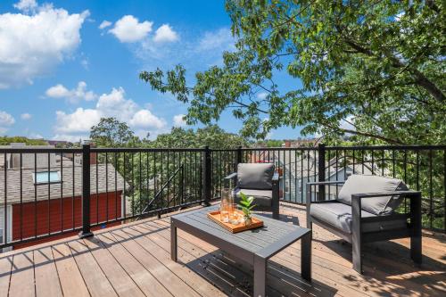 a patio with two chairs and a table on a deck at 3BR3Bth Penthouse 2 Parking Spaces TD MIT Harvard in Somerville