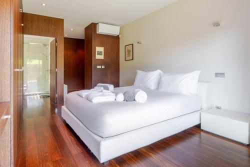 a bedroom with a white bed with white pillows at Stars View by Portugal Active in Fafe