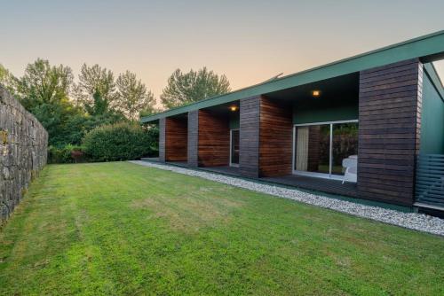 a house with a green lawn in front of it at Stars View by Portugal Active in Fafe