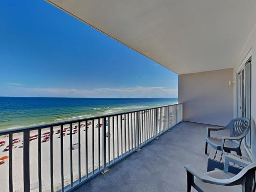 a balcony with two chairs and a view of the ocean at Windemere #606 in Perdido Key