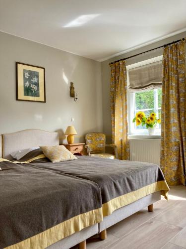a bedroom with a large bed and a window at Landhaus Hohe Buchen in Plön