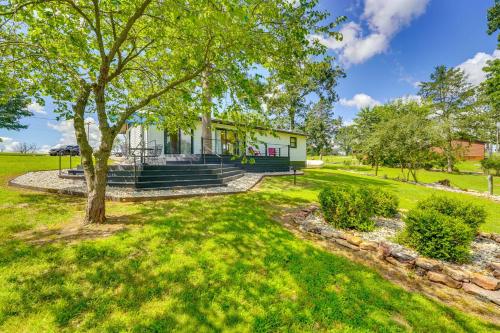 an image of a house with a tree at Near Table Rock Lake Family Home with Deck and Views in Golden